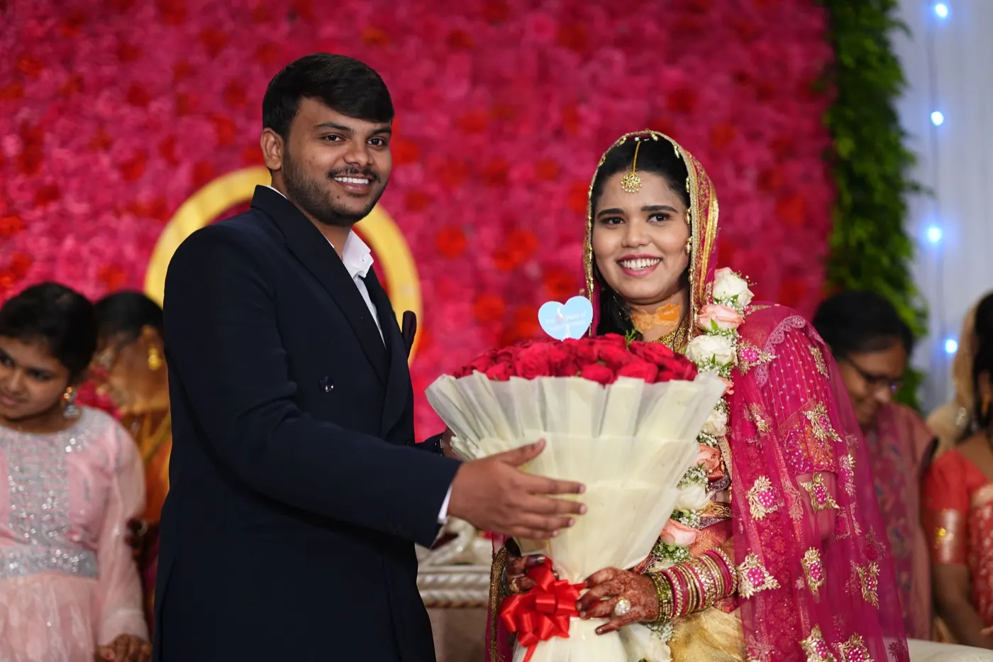 Fathima and Hasnad smiling together with a bouquet at their engagement
